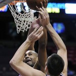 Phoenix Suns' Grant Hill, rear, goes up with a shot as New Jersey Nets' Ryan Anderson defends during the fourth quarter of an NBA basketball game Tuesday night, Nov. 4, 2008, in East Rutherford, N.J. The Suns beat the Nets 114-86. (AP Photo/Bill Kostroun)