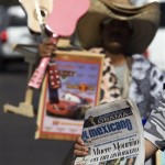 A vendor sells a local newspaper highlighting the death of Mexico's Secretary of the Interior, Juan Camilo Mourino, and Sen. Barack Obama's victory in U.S. presidential election at the San Ysidro border crossing in Tijuana, Mexico, Wednesday, Nov. 5, 2008. Mourino, one of Mexico's top pointmen in the war against drug trafficking, died when a government jet crashed Tuesday night into a Mexico City street. (AP Photo/Guillermo Arias)