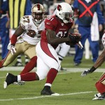 Arizona Cardinals' Anquan Boldin (81) scores a touchdown as San Francisco 49ers' Walt Harris (27) and Tarell Brown, right, defend during the second quarter of an NFL football game Monday, Nov. 10, 2008, in Glendale, Ariz. (AP Photo/Ross D. Franklin)