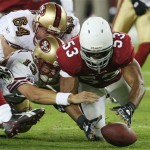San Francisco 49ers' Shaun Hill, left, gets his fumble recovered by Arizona Cardinals' Clark Haggans (53) as 49ers' David Baas (64) arrives late to help in the third quarter of an NFL football game Monday, Nov. 10, 2008 in Glendale, Ariz. The Cardinals defeated the 49ers 29-24. (AP Photo/Ross D. Franklin)