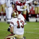 San Francisco 49ers quarterback Shaun Hill (13) watches from his knees after throwing an interception against the Arizona Cardinals during the fourth quarter of an NFL football game Monday, Nov. 10, 2008 in Glendale, Ariz. At rear is Cardinals' Ralph Brown. (AP Photo/Matt York)