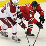 Chicago Blackhawks' Matt Walker (8) battles for the puck with Phoenix Coyotes' Shane Doan (19) in the first period of an NHL hockey game Tuesday, Nov. 18, 2008 in Glendale, Ariz. (AP Photo/Ross D. Franklin)