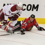 Chicago Blackhawks' Aaron Johnson (23) tries to keep Phoenix Coyotes' Shane Doan (19) away from the puck in the third period of an NHL hockey game Tuesday, Nov. 18, 2008 in Glendale, Ariz. The Blackhawks defeated the Coyotes 3-2 in a shootout. (AP Photo/Ross D. Franklin)