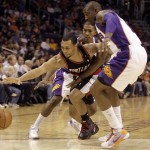 Portland Trail Blazers guard Brandon Roy, front left, has the ball knocked away by Phoenix Suns forward Amare Stoudemire, front right, as Roy attempts to drive between Stoudemire and Suns guard Raja Bell, rear, in the first quarter of an NBA basketball game Saturday, Nov. 22, 2008, in Phoenix. (AP Photo/Paul Connors)