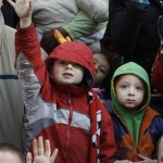 Jack Gross, six, left, and his four year-old brother Tommy, right, from Chicago, react differently as they see santa Claus at the end of the Thanksgiving Day Parade in Chicago's famed Loop, Thursday, Nov. 27, 2008. (AP Photo/Charles Rex Arbogast)
