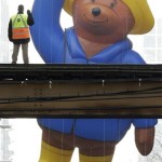 The Paddington Bear helium balloon appears to be waving to a Chicago Transit Authority worker on the elevated tracks inside Chicago's famed Loop during the Thanksgiving Day Parade in Chicago, Thursday, Nov. 27, 2008. (AP Photo/Charles Rex Arbogast)
