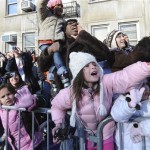 The crowd reacts to Miley Cyrus passing by aboard the "Bolt" float in celebration of the 82nd annual Macy's Thanksgiving Day parade,Thursday, Nov. 27, 2008, in New York. (AP Photo/Louis Lanzano)

