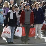 Shoppers on a crowded State Street carry bags as they wait to cross the street in Chicago's Loop Friday, Nov. 28, 2008, the day after Thanksgiving, the traditional start of the holiday shopping season. (AP Photo/Charles Rex Arbogast)