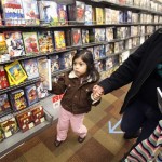 Ashley Martinez, 3, of Falls Church, Va., holds a DVD as she shops with her mother at a Circuit City store on Black Friday, the first shopping day after Thanksgiving, Friday, Nov. 28, 2008, in Baileys Crossroads, Va. (AP Photo/Gerald Herbert)