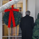 President George W. Bush enters the holiday decorated Oval Office, Tuesday, Dec. 2, 2008, as he returns from a trip to attend the Roundtable on Mentoring Children of Prisoners Initiative in Greensburo, N.C. (AP Photo/Ron Edmonds)