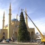 Workers lower a star atop a giant Christmas tree near the Mohammad al-Amin Mosque in Beirut, Lebanon, Thursday, Dec. 4, 2008. (AP Photo/Ahmad Omar)