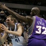 Dallas Mavericks forward Dirk Nowitzki (41), of Germany, looks for an opening against Phoenix Suns center Shaquille O'Neal (32) in the first half of an NBA basketball game in Dallas, Thursday, Dec. 4, 2008. (AP Photo/Tony Gutierrez)