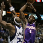 Phoenix Suns forward Amare Stoudemire (1) attempts a shot over Dallas Mavericks center Erick Dampier (25) in the second half of an NBA basketball game in Dallas, Thursday, Dec. 4, 2008. Stoudemire had a team-high 28 points in the 112-97 loss to the Mavericks. (AP Photo/Tony Gutierrez)