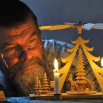 Wood carver Juergen Weinrich works at a Christmas pyramid in his studio in Glashuette, eastern Germany, 25 miles south of Dresden, Friday, Dec. 12, 2008. The traditional wooden Christmas pyramids manufactured in the Erzgebirge mountain region are sold all over the world. (AP Photo/Matthias Rietschel)