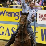 Travis Tryan, of Billings, Mont., celebrates tying the world record in the team roping competition during the eighth go-round of the National Finals Rodeo in Las Vegas, Thursday, Dec. 11, 2008. Tryan and his partner Cory Petska finished in 3.5 seconds. (AP Photo/Isaac Brekken)
