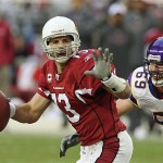 Arizona Cardinals' Kurt Warner, left, tries to elude Minnesota Vikings' Jared Allen (69) in the fourth quarter of an NFL football game Sunday, Dec. 14, 2008 in Glendale, Ariz. Warner was sacked on the play, and the Vikings defeated the Cardinals 35-14. (AP Photo/Ross D. Franklin)