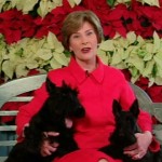 This video image provided by the White House shows first lady Laura Bush with Barney and Miss Beazley appearing in the "Barney Cam" holiday doggie video. (AP Photo/White House)