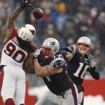 New England Patriots quarterback Matt Cassel throws past the outstretched arm of Arizona Cardinals defensive tackle Darnell Dockett as Nick Kaczur blocks during the Patriots' 44-7 win in an NFL football game in Foxborough, Mass., Sunday, Dec. 21, 2008. (AP Photo/Winslow Townson)
