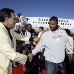 Texas defensive lineman Brandon Madden, right, is greeted by Fiesta Bowl ambassador Manny Molina, left, upon arrival Monday, Dec. 29, 2008, at Sky Harbor International Airport in Phoenix. Texas will play Ohio State in the Fiesta Bowl on Jan. 5. (AP Photo/Paul Connors)