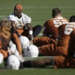 Texas linebacker Brian Orakpo, rear top, stretches out prior to football practice Tuesday, Dec. 30, 2008, in Scottsdale, Ariz. Texas will play Ohio State in the Fiesta Bowl on Monday, Jan. 5, 2009. (AP Photo/Paul Connors)
