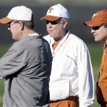 Texas coach Mack Brown, center, talks with offensive coordinator Greg Davis, left, and defensive coordinator Will Muschamp, right, during football practice Wednesday, Dec. 31, 2008, in Scottsdale, Ariz. Texas will play Ohio State in the Fiesta Bowl NCAA college football game on Monday, Jan. 5, 2009. (AP Photo/Paul Connors)