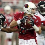 Arizona Cardinals quarterback Kurt Warner is pressured by Atlanta Falcons' Lawyer Millory, left, during the first quarter of an NFC wild-card playoff football game Saturday, Jan. 3, 2009 in Glendale, Ariz. (AP Photo/Ross D. Franklin)