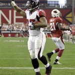 Atlanta Falcons running back Michael Turner celebrates his touchdown as Arizona Cardinals' Antrel Rolle (21) walks away during the second quarter of an NFL wild-card playoff football game Saturday, Jan. 3, 2009 in Glendale, Ariz. (AP Photo/Paul Connors)
