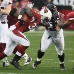 Arizona Cardinals running back Edgerrin James (32) fights for yardage as teammate tight end Ben Patrick (89) attempts to block Atlanta Falcons defensive end Chauncey Davis, back, during the first quarter of an NFL wild-card playoff football game on Saturday, Jan. 3, 2009 in Glendale, Ariz. (AP Photo/Ross D. Franklin)
