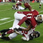 Arizona Cardinals wide receiver Larry Fitzgerald, top, tries to dive for the first down marker after making a catch as Atlanta Falcons cornerback Domonique Foxworth, bottom, makes the tackle during the fourth quarter of an NFL wild-card playoff football game on Saturday, Jan. 3, 2009 in Glendale, Ariz. The Cardinals defeated the Falcons 30-24. (AP Photo/Ross D. Franklin)