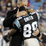 Carolina Panthers owner Jerry Richardson, back, embraces receiver Steve Smith before their NFL divisional playoff football game against the Arizona Cardinals in Charlotte, N.C., Saturday, Jan. 10, 2009. (AP Photo/Gerry Broome)
