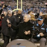 Carolina Panthers owner Jerry Richardson waves at fans as he is carted off the field before an NFL divisional playoff football game against the Arizona Cardinals in Charlotte, N.C., Saturday, Jan. 10, 2009. (AP Photo/Rick Havner)
