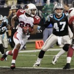 Arizona Cardinals' Dominique Rodgers-Cromartie (29) is chased by Carolina Panthers' Jeff King (47) and Steve Smith (89) after intercepting a pass during the second quarter of an NFL divisional playoff football game in Charlotte, N.C., Saturday, Jan. 10, 2009. (AP Photo/Rick Havner)