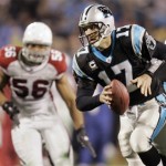 Carolina Panthers quarterback Jake Delhomme (17) scrambles as he is pursued by Arizona Cardinals' Chike Okeafor (56) during the second quarter of an NFL divisional playoff football game in Charlotte, N.C., Saturday, Jan. 10, 2009. (AP Photo/Gerry Broome)