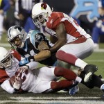 Arizona Cardinals' Ralph Brown (20) intercepts a pass in the end zone intended for Carolina Panthers' Steve Smith, center, as Arizona Cardinals' Antrel Rolle (21) closes in during the fourth quarter of an NFL divisional playoff football game in Charlotte, N.C., Saturday, Jan. 10, 2009. (AP Photo/Chuck Burton)
