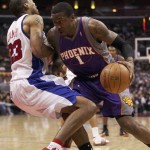 Phoenix Suns' Amare Stoudemire (1) drives to the basket on Los Angeles Clippers' Marcus Camby during the first half of an NBA basketball game Sunday, Jan. 11, 2009, in Los Angeles. (AP Photo/Kevin Reece)