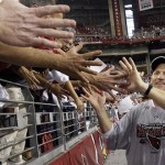 Arizona Cardinals head coach Ken Whisenhunt celebrates with fans after the NFL NFC championship football game against the Philadelphia Eagles Sunday, Jan. 18, 2009, in Glendale, Ariz. The Cardinals won 32-25. (AP Photo/Ross D. Franklin)