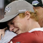 Arizona Cardinals head coach Ken Whisenhunt is embraced by his son, Ken Whisenhunt, Jr. after the NFL NFC championship football game against the Philadelphia Eagles Sunday, Jan. 18, 2009, in Glendale, Ariz. The Cardinals won 32-25. (AP Photo/Mark J. Terrill)
