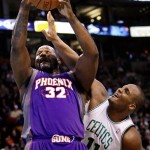 Boston Celtics forward Glen Davis (11) battles for a rebound with Phoenix Suns center Shaquille O'Neal (32) during the first half of their NBA basketball game in Boston, Monday Jan. 19, 2009. (AP Photo/Charles Krupa)