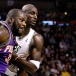 Phoenix Suns center Shaquille O'Neal, left, and Boston Celtics forward Kevin Garnett, rear, battle for a rebound during the first half of an NBA basketball game in Boston, Monday Jan. 19, 2009. (AP Photo/Charles Krupa)