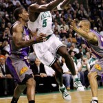 Boston Celtics forward Kevin Garnett (5) drives between Phoenix Suns center Amare Stoudemire, left, and forward Grant Hill during the first half of an NBA basketball game in Boston, Monday Jan. 19, 2009. (AP Photo/Charles Krupa)