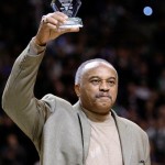 Olympian Tommie Smith holds up his "Heros Among Us" award during the first half of a NBA basketball game between the Boston Celtics and Phoenix Suns in Boston, Monday Jan. 19, 2009. Smith, who during the 1968 Olympics stood on the victory stand in Mexico City with his head bowed and his fist raised, was honored during the game.(AP Photo/Charles Krupa)