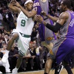 Boston Celtics guard Rajon Rondo (9) looks to pass as he is pressured by Phoenix Suns center Amare Stoudemire (1) and forward Louis Amundson (17) during the second half of an NBA basketball game in Boston, Monday, Jan. 19, 2009. Rondo had 23 points in the Celtics' 104-87 win. (AP Photo/Charles Krupa)