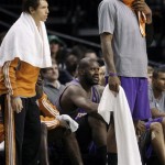 Phoenix Suns guard Steve Nash, left, center Shaquille O'Neal, seated, and center Amare Stoudemire, right, watch from the bench late in the second half of an NBA basketball game against the Boston Celtics in Boston, Monday Jan. 19, 2009. The Celtics beat the Suns 104-87. (AP Photo/Charles Krupa)