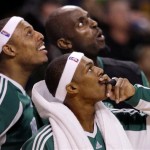 Boston Celtics guard Rajon Rondo, bottom right, watches the replay of a dunk by forward Bill Walker with teammates Paul Pierce, left, and Kevin Garnett, rear, during the second half of an NBA basketball game against the Phoenix Suns in Boston, Monday Jan. 19, 2009. The Celtics beat the Suns 104-87. (AP Photo/Charles Krupa)