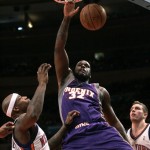 Phoenix Suns' Shaquille O'Neal (32) dunks the ball over New York Knicks' Al Harrington, left and Knicks' David Lee, right, during the first half of an NBA basketball game Wednesday, Jan. 21, 2009 in New York. (AP Photo/Frank Franklin II)