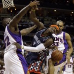 Charlotte Bobcats guard Gerald Wallace (3) is fouled as he drives between Phoenix Suns forward Grant Hill (33) and Shaquille O'Neal (32) during the first half of an NBA basketball game in Charlotte, N.C., Friday, Jan. 23, 2009. (AP Photo/Chuck Burton)