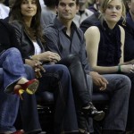 NASCAR driver Jeff Gordon, center, looks on with his wife, Ingrid Vandebosch, left, during the Charlotte Bobcats' NBA basketball game against the Phoenix Suns in Charlotte, N.C., Friday, Jan. 23, 2009. (AP Photo/Chuck Burton)