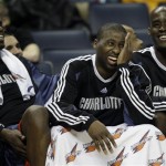 Charlotte Bobcats players, from left, Nazr Mohammed, Raymond Felton, and Emeka Okafor, share a laugh as they watch the final minutes of the Bobcats' 98-76 win over the Phoenix Suns in an NBA basketball game in Charlotte, N.C., Friday, Jan. 23, 2009. (AP Photo/Chuck Burton)