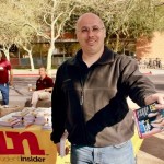 Scott Bernstein distributes coupon books to students outside the ASU bookstore. (Rose Clements/KTAR)