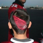 A woman shaved the Arizona Cardinals insignia in the back of her son's haircut. They were some of the fans gathered at Phoenix Sky Harbor airport on Monday, January 26, 2009 to send the team off to Tampa Bay for Super Bowl XLIII. (Jim Cross/KTAR)